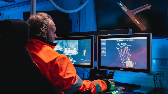 Person in AutoMine control room with screens